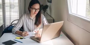Young professional working remotely on a laptop from home, exploring entry-level job opportunities based on skills